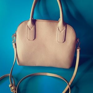 A blue and gold clutch cross body bag.